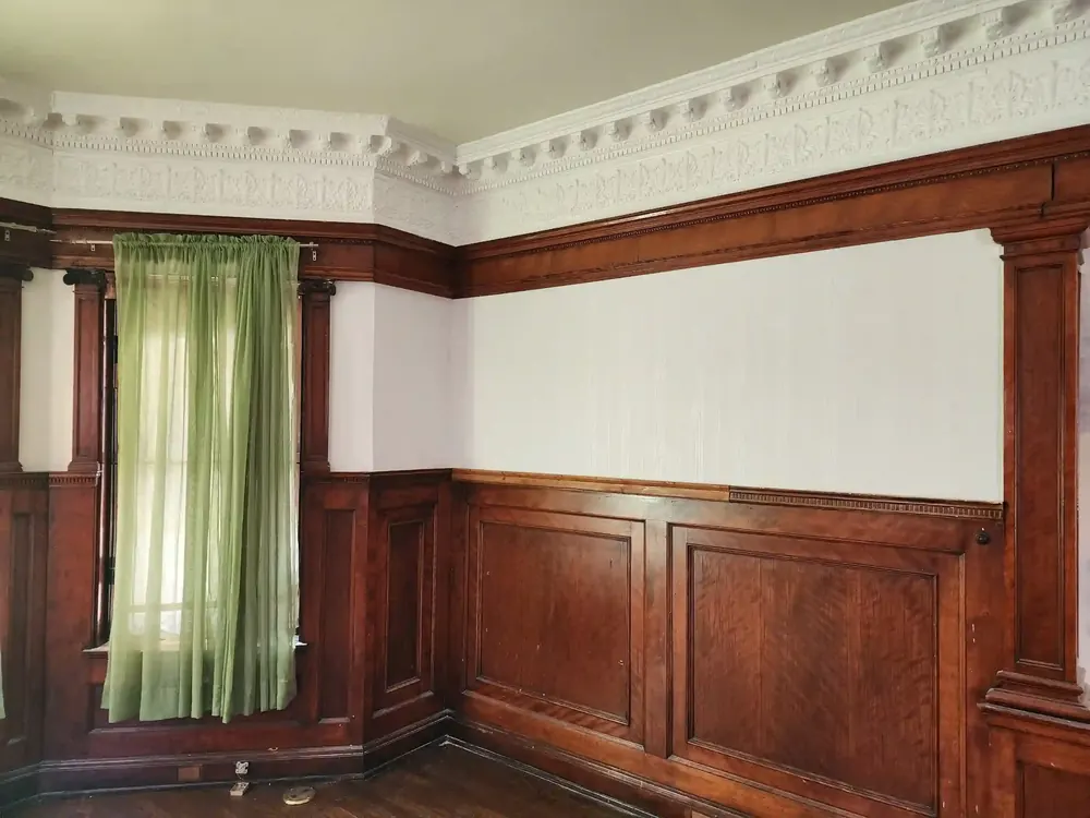 Patterned wallpaper framing a dining space